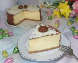 Pyszny sernik z mascarpone, udekorowany czekoladowymi jajeczkami i wiórkami białej czekolady, na wielkanocnym stole.