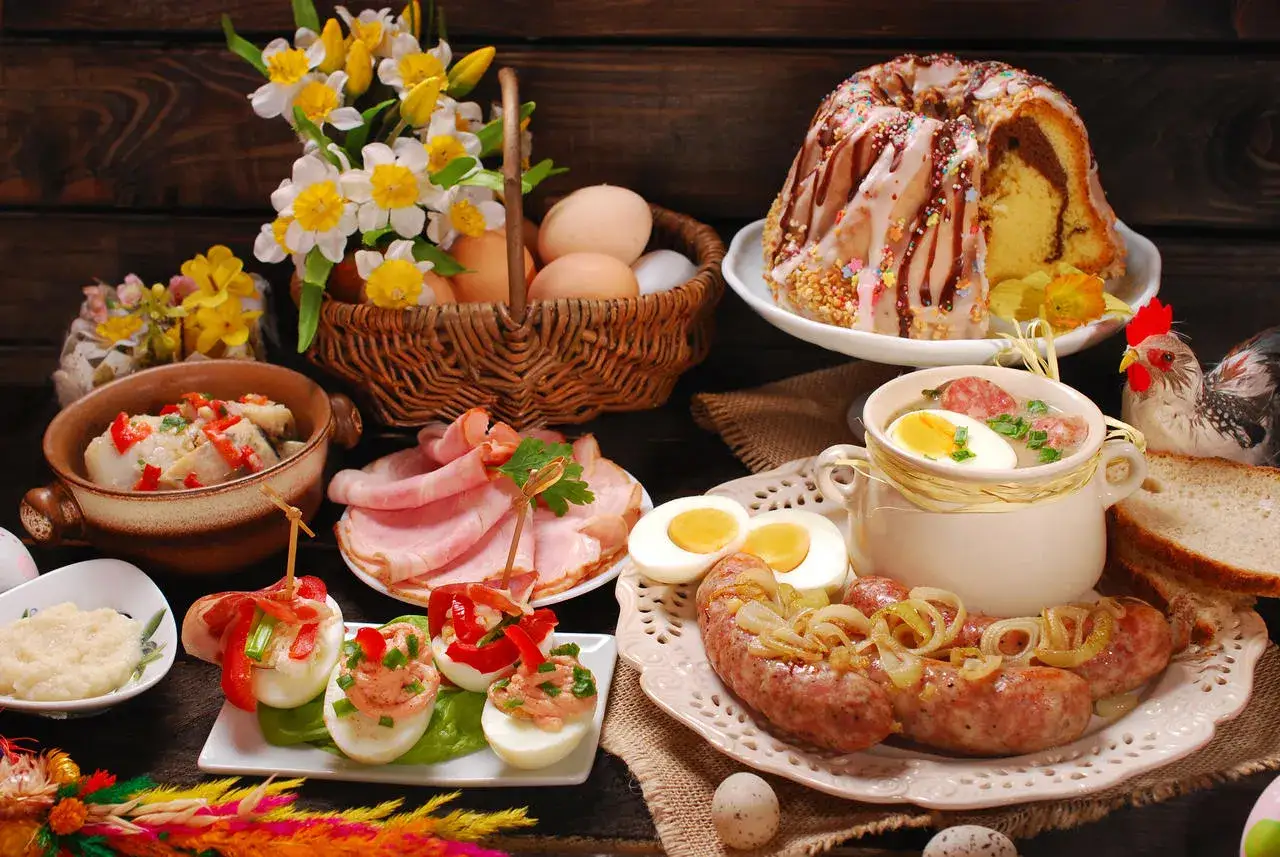 Wielkanocne potrawy: babka, biała kiełbasa, jajka faszerowane, chrzan, śledzie, wędlina i żurek. Lista przysmak&oacute;w na świątecznym stole.